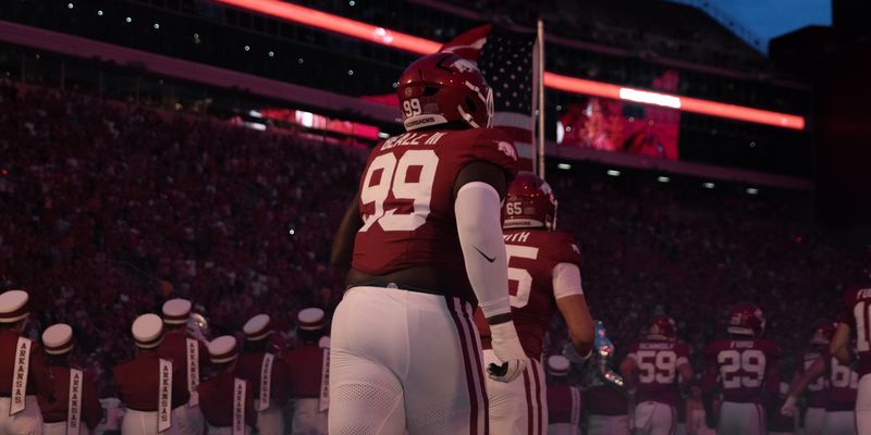 Razorback number 99 stands on the field before kickoff