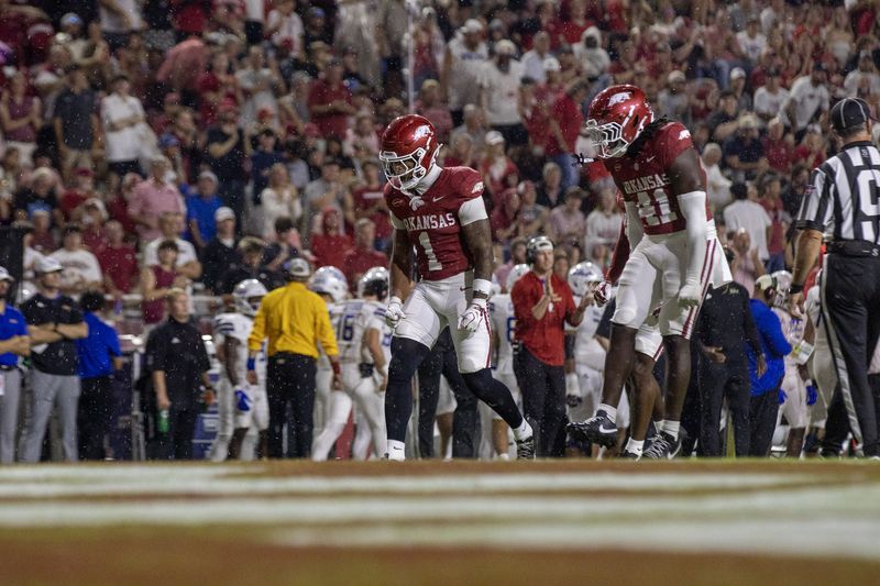 Two Razorback players react in the end zone during a night game